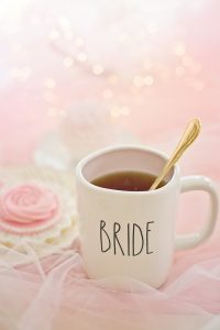 Bridal shower mug amongst tulle fabric, sweets and shimmery lights.